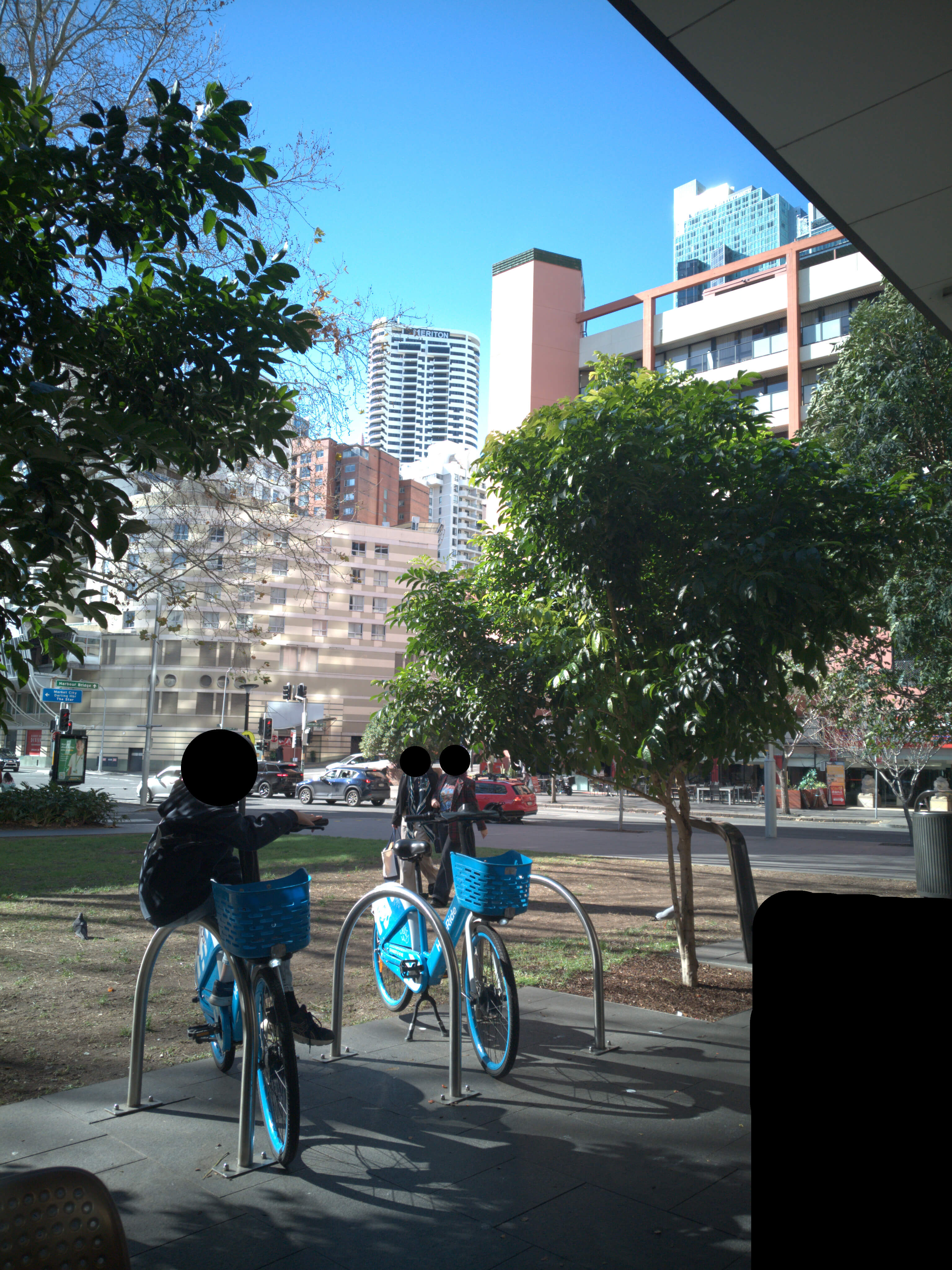 A miscellaneous photo of several buildings in the distance including a Meriton hotel building.