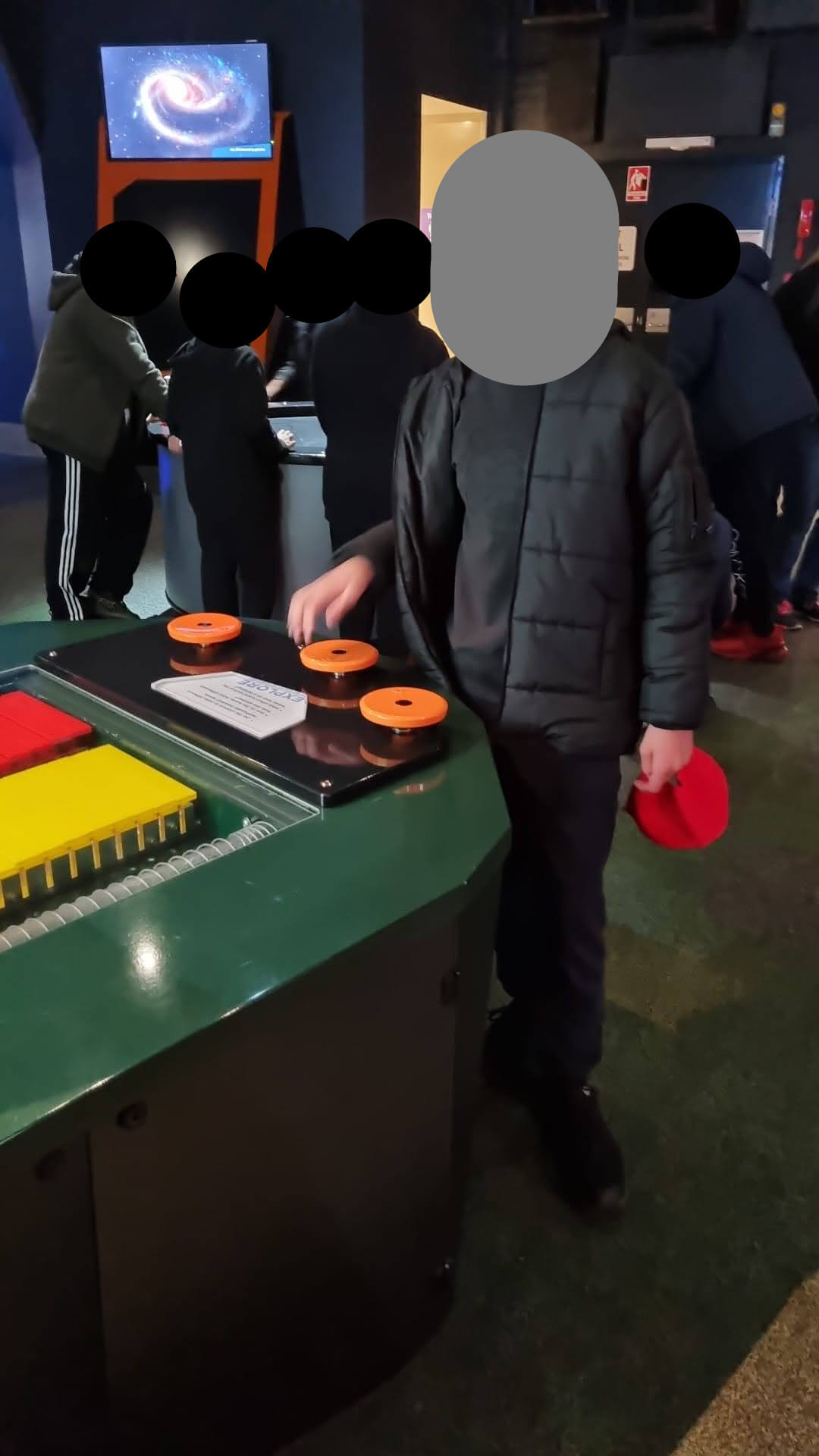 Me smiling alongside a science thingamabob located somewhere in Questacon.